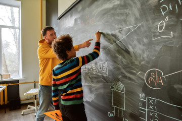 Teacher helping student to construct a right angled triangle