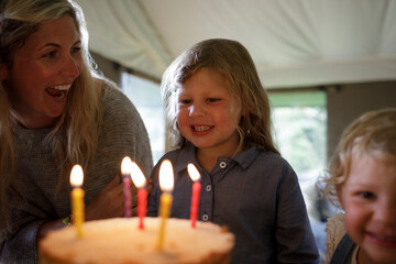 Parent celebrating her child's birthday with joy