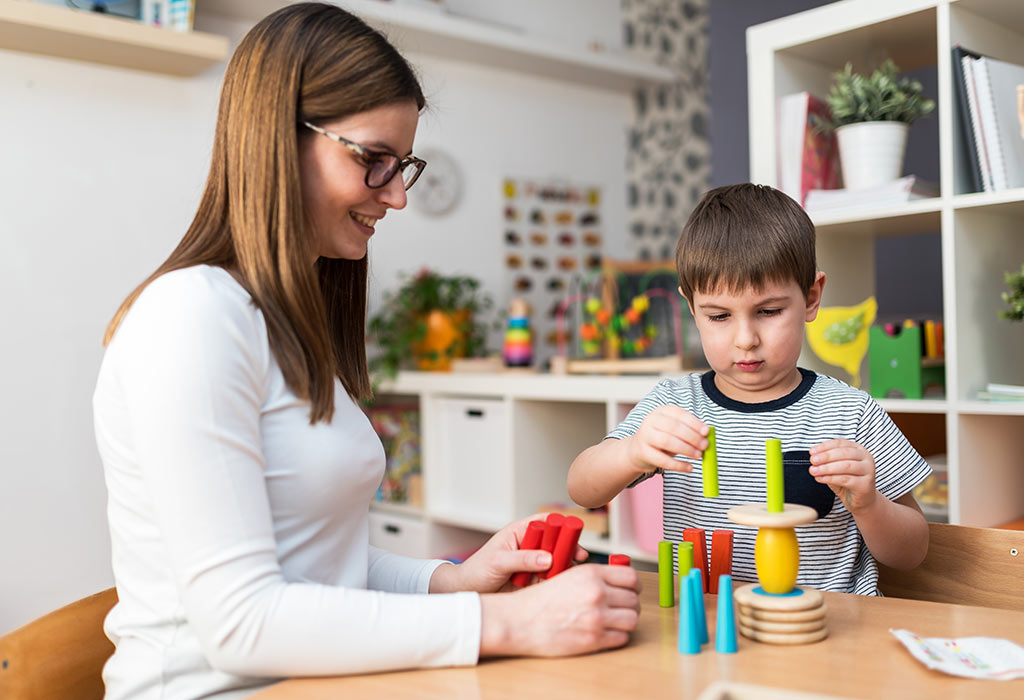 Mother and kid playing with objects and shapes