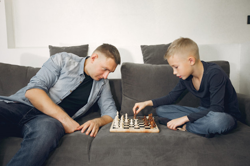 Kid playing board games with his dad