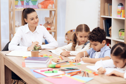 Project based learning teacher paying attention to kids in the project