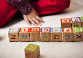 Kid rearranging alphabets in blocks