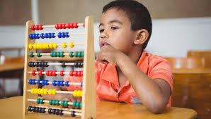 kid doing math with the help of abacus