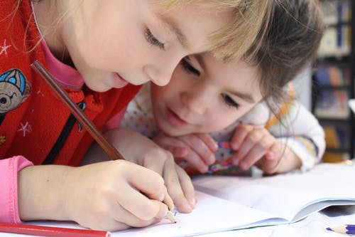 School children learning and interacting with each other