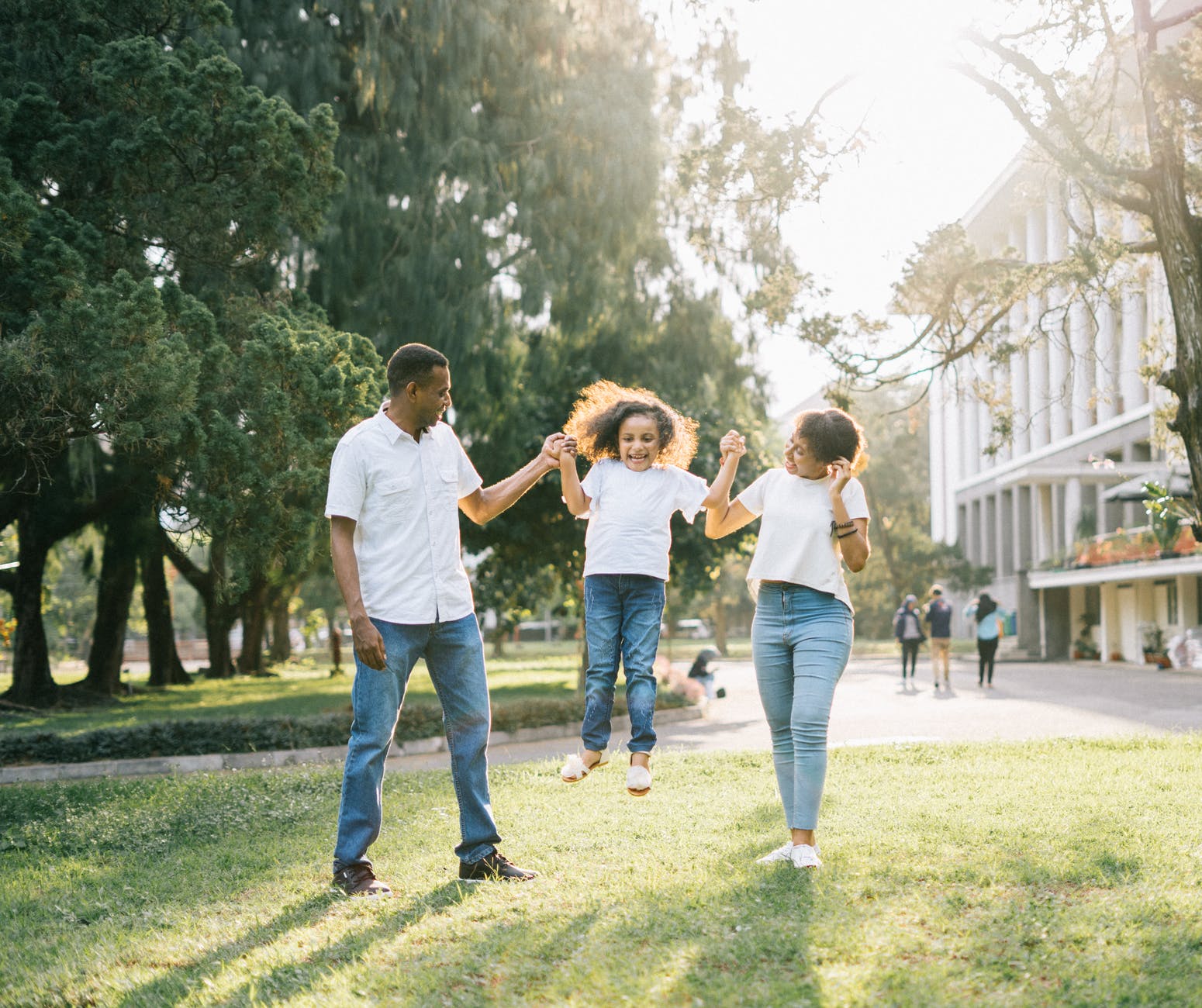 Kid Jumping in joy with parents