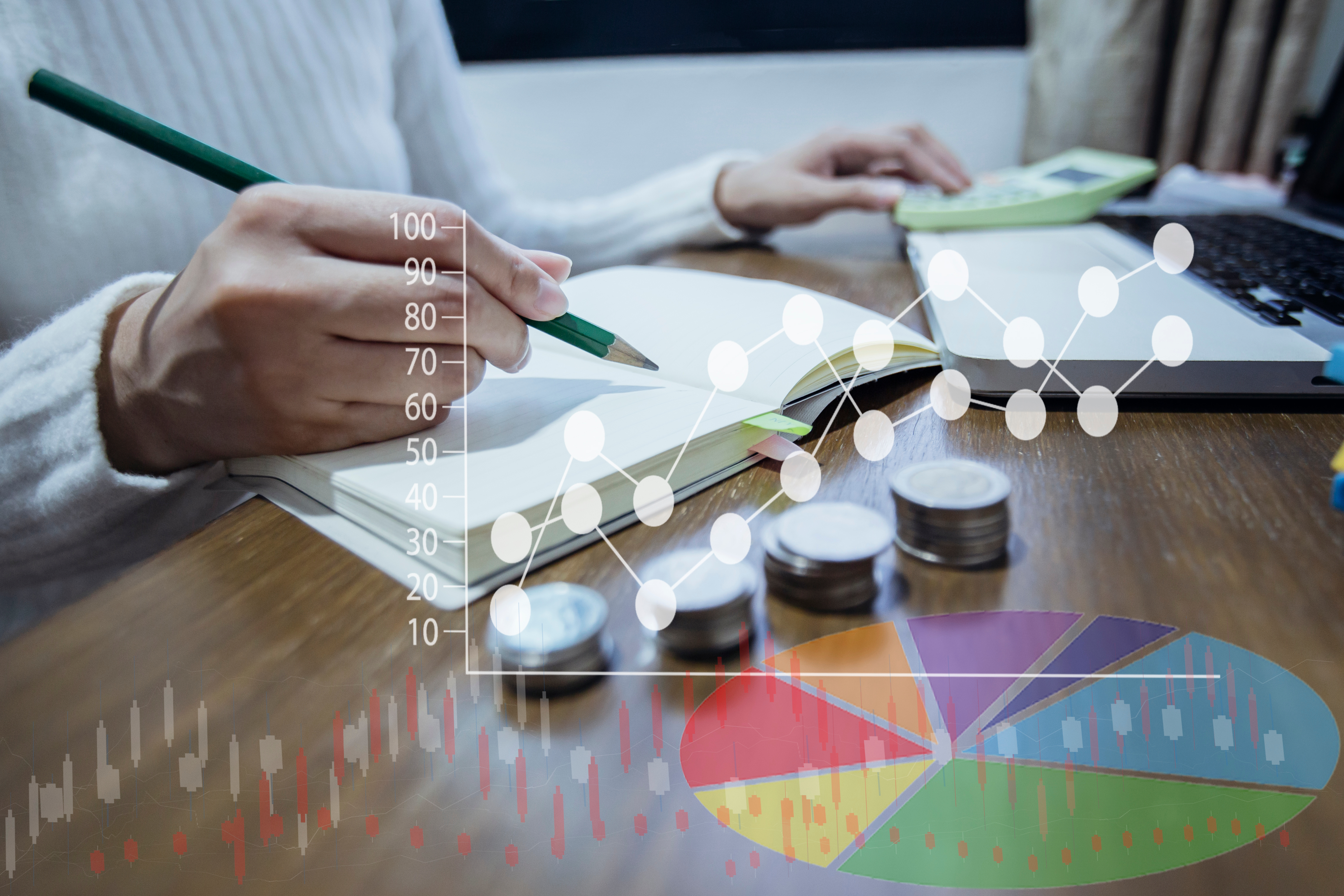 Businesswoman hand doing finances and calculate on desk office with rows of coins and bar chart information related to business and finance concept.