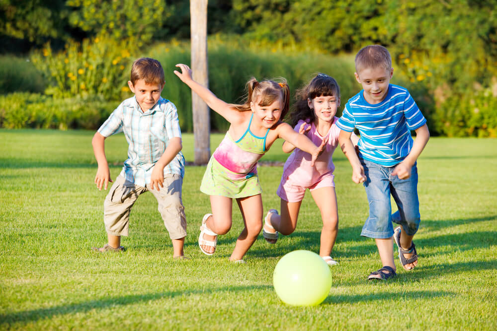 Kids playing football on ground
